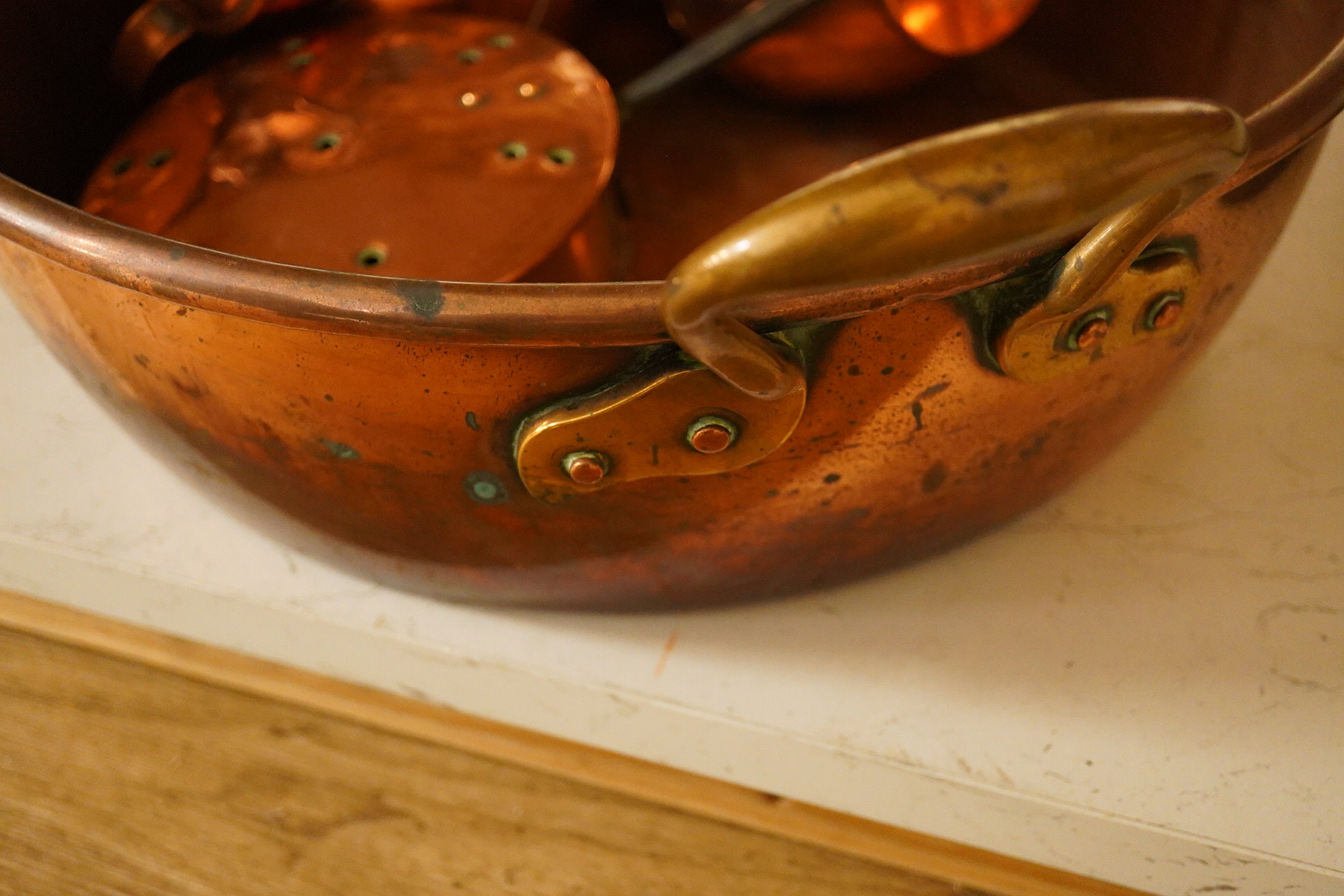 Five copper items including a large jelly mould, a two handled pan, two jugs and a chestnut roaster, pan 41cm diameter. Condition - fair to good